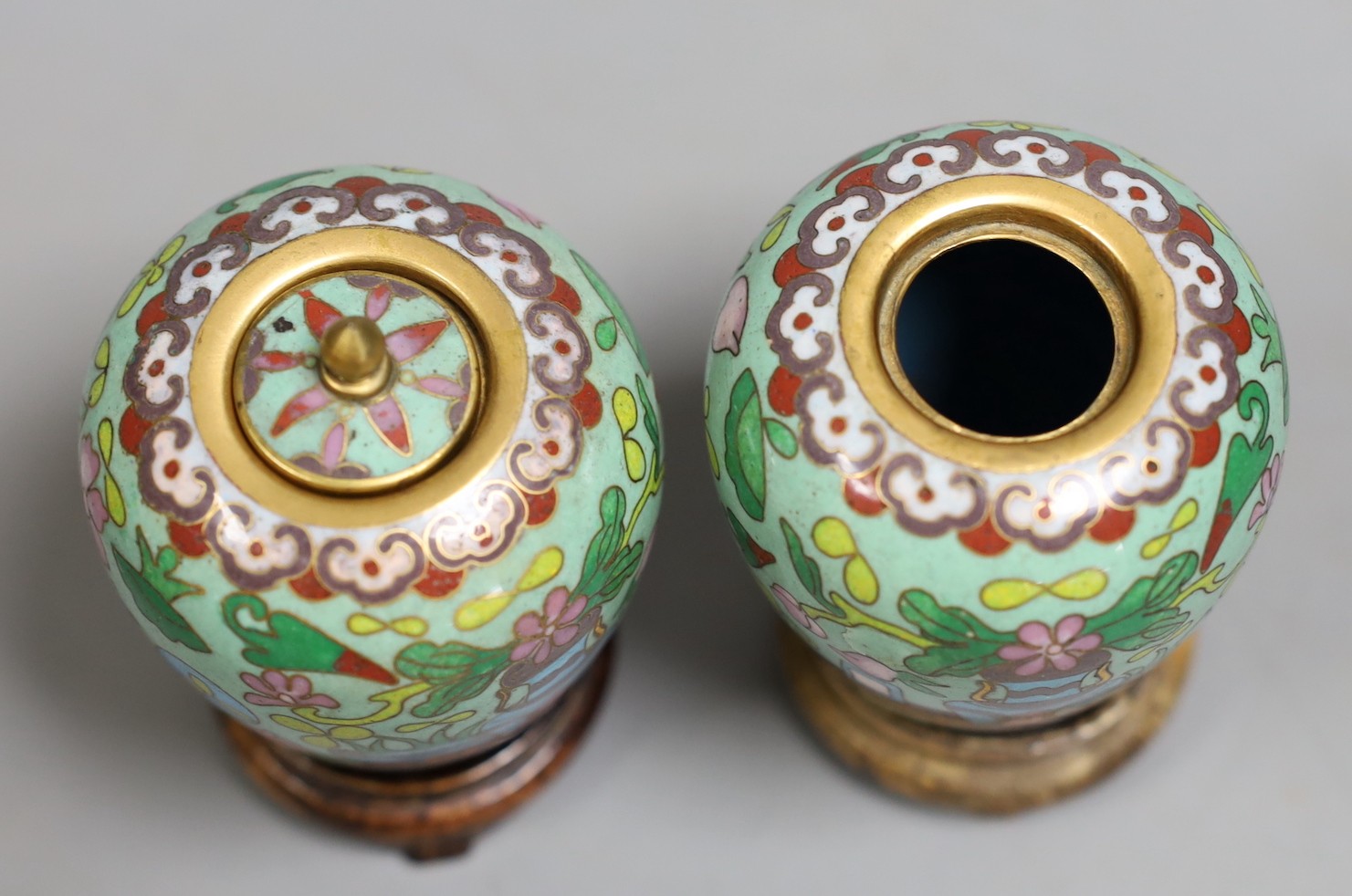 A pair of Chinese cloisonné enamel jars, wood stands, 9cm